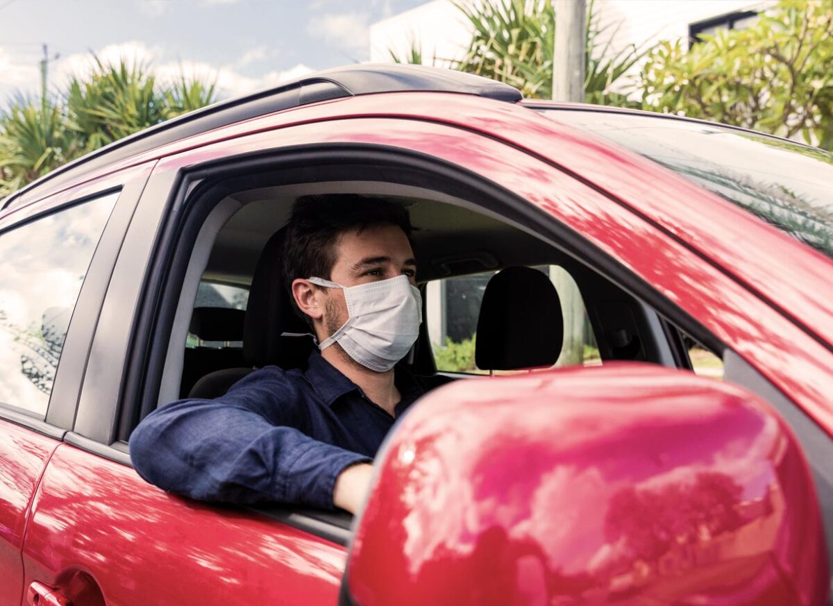 Article image of man wearing mask while driving