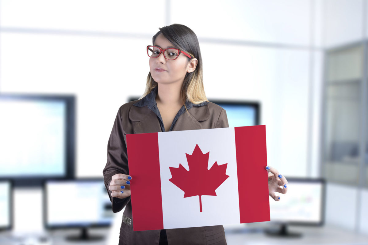 Article image of woman holding Canadian flag